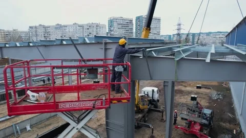 Builders build a modern metal frame roof. drone view Video stock 172129396