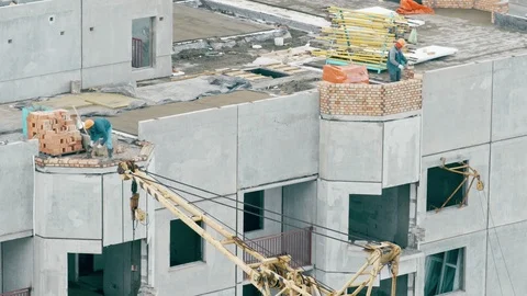 Builders build a multi-storey house Stock Footage 88970749