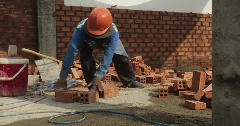 Builders building a brick wall. Construction work on construction.The master Stock Footage 306229317