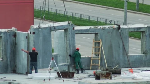 Builders Carefully Place Concrete Wall Section. Teamwork In Prefabricated House Stock-Footage 322094852
