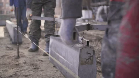Builders carry curb stone at construction site Stock Footage 237450883