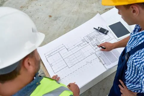 Builders Checking Blueprints on Site 写真素材