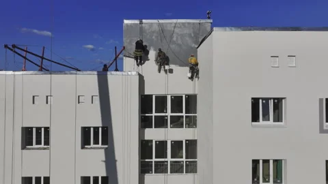 Builders coat wall with paint ensuring thorough coverage Stock-Footage 275070560
