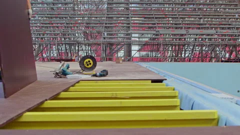 Builders constructing running path near swimming pool Stock Footage 235351579