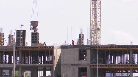 Builders on the construction site erect a monolithic building, Stock Footage 136697800