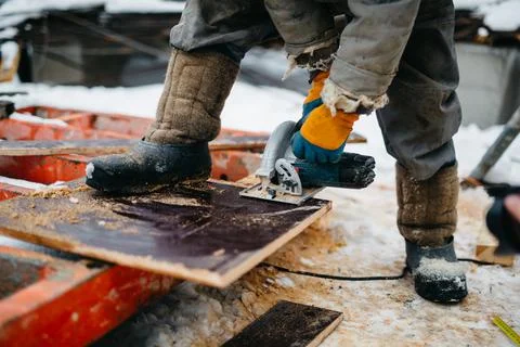 Builders at construction site make engineering calculations and cut materials Stock Photos