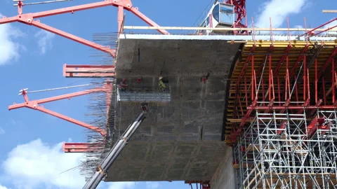 Builders in crane control concrete part of bridge section Video stock 249182220
