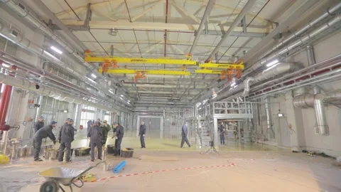 Builders create a self-leveling floor. The builders do the work inside. Creation Stock Footage 233622118