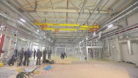 Builders create a self-leveling floor. The builders do the work inside. Creation Stock Footage 234414816