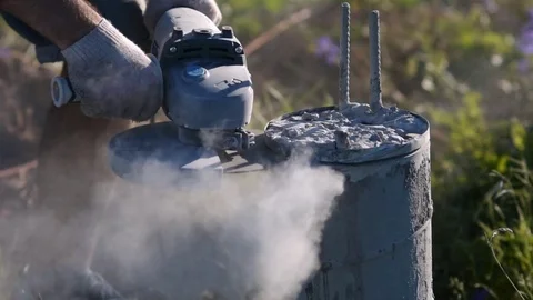 Builder's cutting tool of a concrete column. Sparks of metal and concrete dust. Stock Footage 72599513