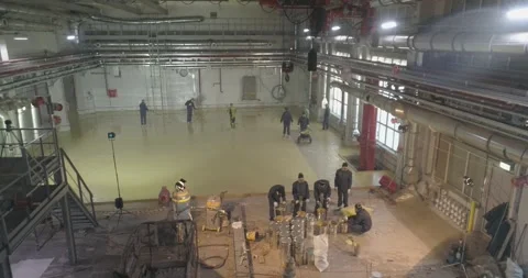 The builders do the work inside. Builders create a self-leveling floor. Creation Stock Footage 256072338