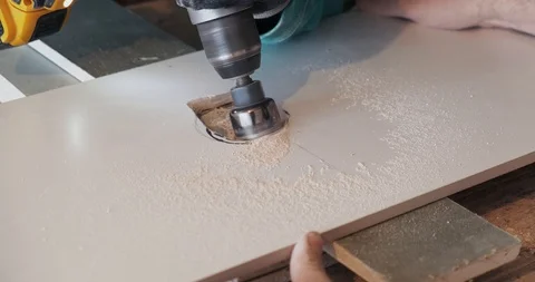 Builders drill hole in ceramic tile with large drill, laying tiles in bathroom Stock Footage 129839390