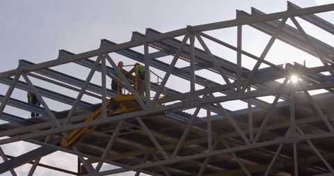 Builders erectors work on the roof of a factory under construction Stock Footage 161960095