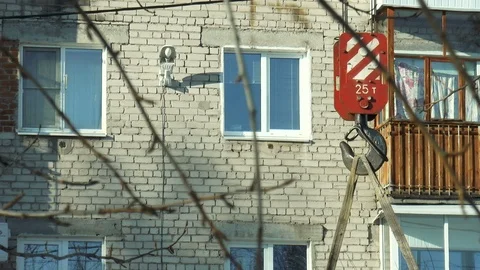 Builders fasten the boards to the crane hook Stock Footage 86650134