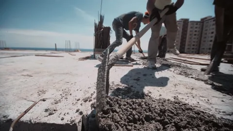 Builders fill in basement of building with cement Stock Footage 143216950