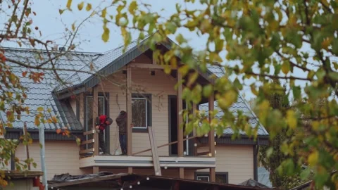 Builders of a frame house, construction of a wooden house Stock Footage 346990302