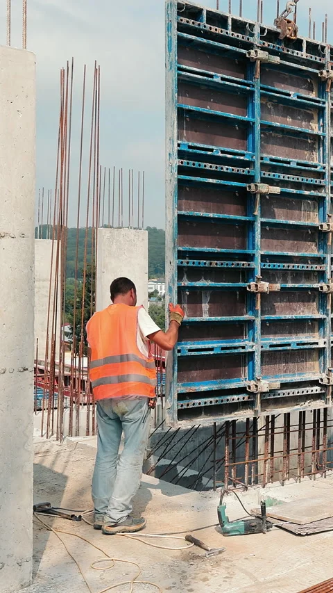 Builders install a large metal structure for pouring monolith. Construction work Stock Footage 317123486