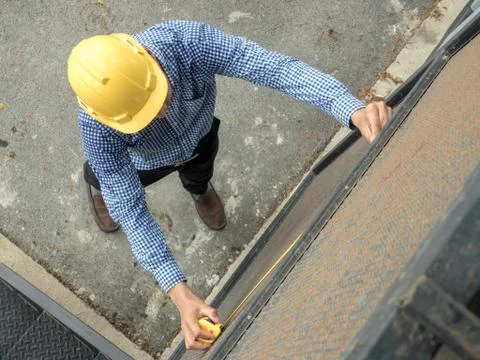 Builders installing measuring windows Stock Photos