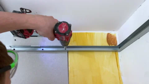 Builders installing metal construction profiles for assembling plasterboards Video stock 154711035