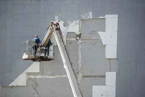 Builders isolate the house by standing on a construction elevator.Copy space Stock Photos