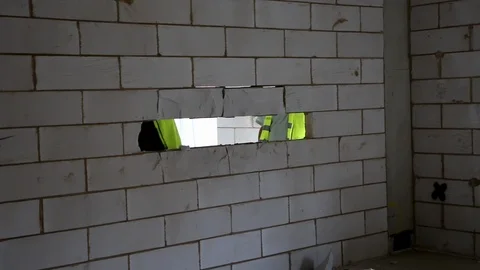 Builders knocking breeze blocks out of a wall Stock Footage 112609467