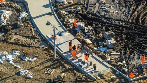 Builders lay tiles in the park Stock Footage 101378844