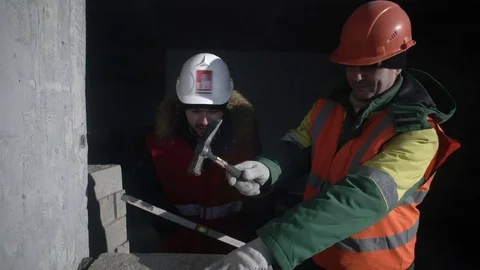 Builders level the stone block Stock Footage 82068037