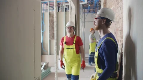 Builders with level tool check wall surface evenness Video stock 133639232