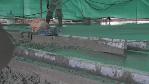 Builders leveling the concrete base Stock Footage 300866096
