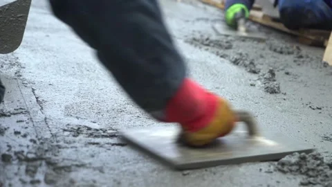 Builders leveling the concrete base Stock Footage 300871489