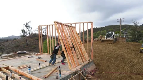 Builders lifting a wooden frame at a construction yard Stock-Footage 228794835