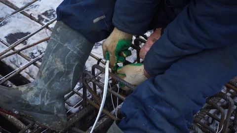 Builders make reinforcement mesh Stock Footage 163566928