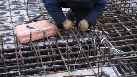 Builders make reinforcement mesh Stock Footage 163566995