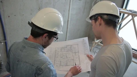 Builders make repairs in apartment in new house, check parameters according to Stock Footage 79075878