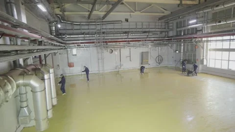 Builders make a self-leveling floor in a factory. Construction of a new workshop Stock-Footage 195626911
