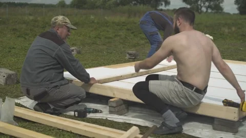 Builders making foundation for new hen house on poultry farm. Stock Footage 247523523