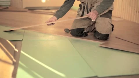 Builders man Install in construction house Laying Laminate Floor Stock Footage 47566909