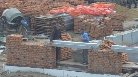 Builders mount the beam on the wall of the house. overlap over Stock-Footage 120675354