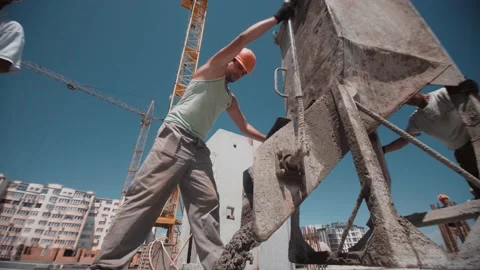 Builders move a container with concrete and pour it on the construction site Stock Footage 143216693