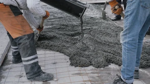 Builders move a container with concrete and pour it on the construction site Stock Footage 152021538