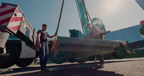 Builders move loads using a mobile truck crane. Lens flare. Stock Footage 136527209
