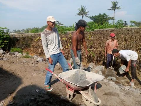 Builders removing broken stone Stock Photos