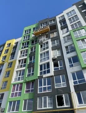 Builders repair facade. Construction workers installers high rise workers Stock Photos
