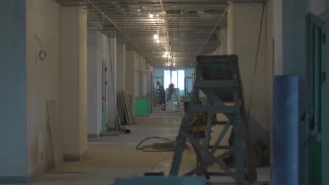Builders rush through hallway filled with noise and motion Stock Footage 311893849