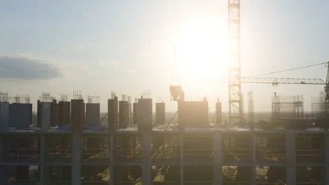 Builders silhouettes on a rooftop of a building under construction Stock Footage 170737396
