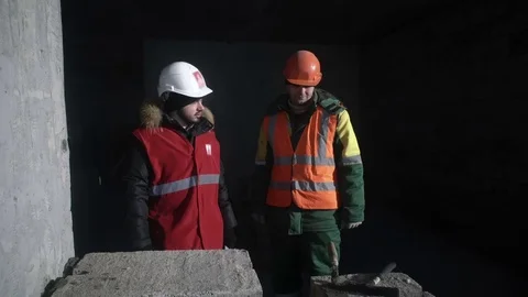 Builders stand and talk about work Stock Footage 82067354