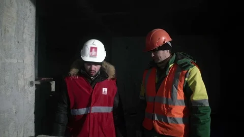 Builders stand and talk Stock Footage 82067669