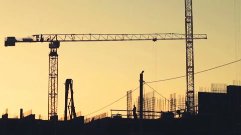 Builders walk through a multi-storey house at sunset Video stock 88503259