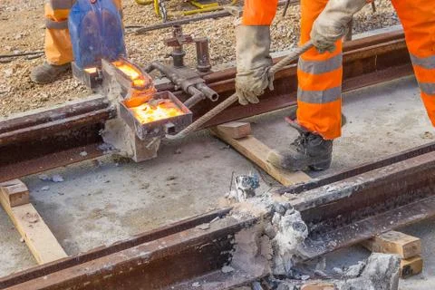 Builders weld and joining segments of the rail Stock Photos