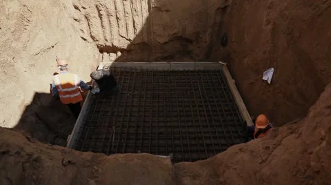 Builders weld metal structure in the pit Stock Footage 61586163
